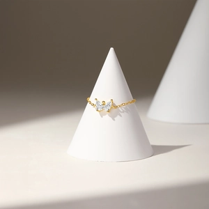 Detailed macro view of kite butterfly zircon chain ring with adjustable gold finish