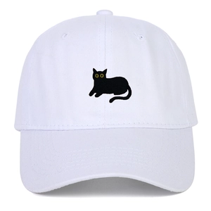 Close-up of black cat embroidery with yellow eyes on white cotton baseball cap