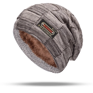 Close-up of thick fleece lining and grey knit texture on warm winter beanie hat