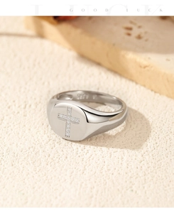 Detailed macro view of S925 silver cross ring with embedded diamonds on textured surface