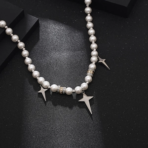 Hip hop pearl necklace featuring silver star pendants and diamond-set metal rings