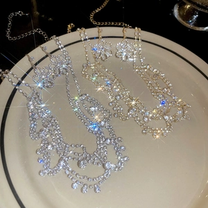 Close-up of sparkling rhinestone flower necklaces in gold and silver luxury finish