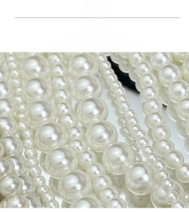 Macro shot of layered cream white pearls in various sizes with elegant silk luster