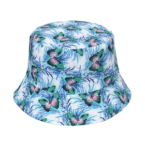 Detailed view of the butterfly and leaf print texture on a white cotton bucket hat