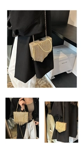 Close-up detail of golden metal tassels and chain strap on a luxury evening clutch bag