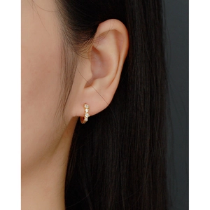 925 silver gold plated hoop earrings with shimmering crystals worn on earlobe