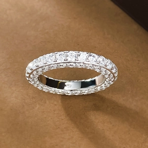 Macro shot of silver eternity ring with three sides of pavé-set round cubic zirconia