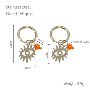 Detail of 18K gold plated stainless steel hoop earrings with evil eye and orange stone