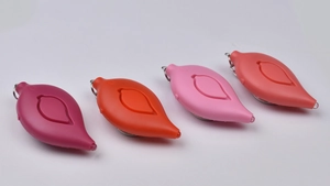 Close-up of four leaf-shaped personal alarms in diverse colors with keychains