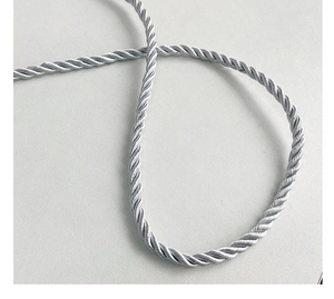 Macro shot of silver braided rope showing silk-like texture and spiral twist details