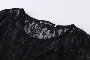 Close-up of black lace dress neckline featuring intricate hollow-out floral patterns