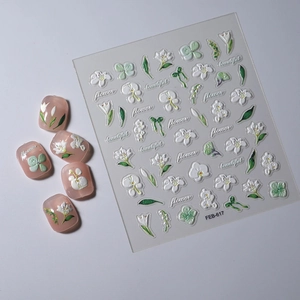 Detail of FEB-617 5D embossed nail stickers featuring white flowers and green leaves