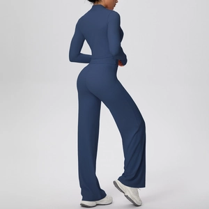 Side-back view of dark blue yoga set with high-waist wide-leg pants and slim zip top