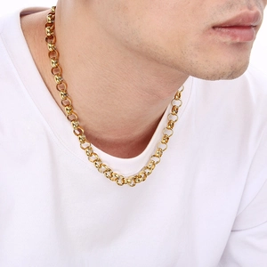 Close-up of a gold-plated stainless steel pearl link necklace worn by a male model