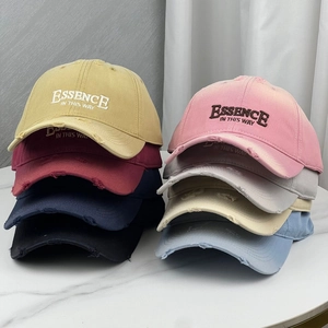 Detailed grid of distressed baseball caps in eight colors featuring essence embroidery