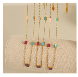 Close-up of 18K gold plated necklace featuring colorful enamel geometric squares