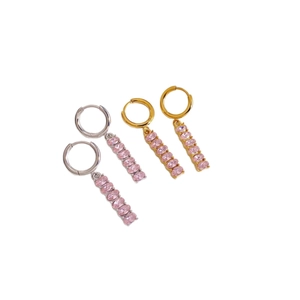 Gold and silver stainless steel earrings with colorful zircon tassel charms on white surface