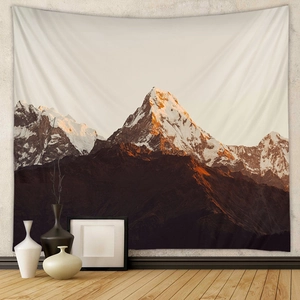 Detail of bohemian mountain tapestry hanging on a textured wall in a home setting