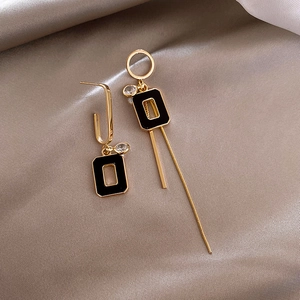 Asymmetric gold tassel earrings with black rectangle pendant and crystals on silk fabric