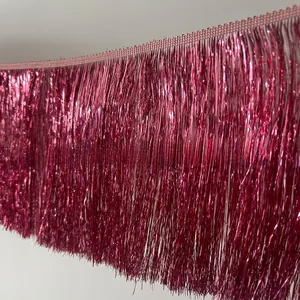 Macro detail of metallic pinkish purple fringe trim with shimmering foil strands for costumes