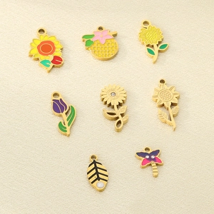 Macro detail of colorful enamel floral pendants with gold finish and rhinestone accents
