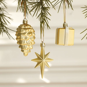 Champagne gold matte Christmas ornaments set featuring pine cones and stars on tree branches