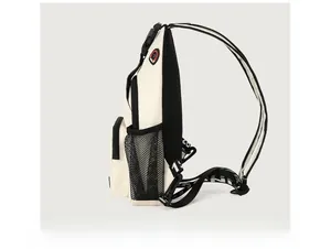 Side view of a cream sling bag showing black breathable mesh back and elastic side pocket
