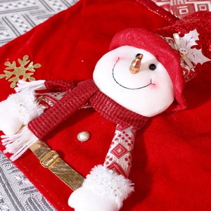 Detail of red velvet Christmas chair cover featuring a 3D snowman with gold snowflake accents