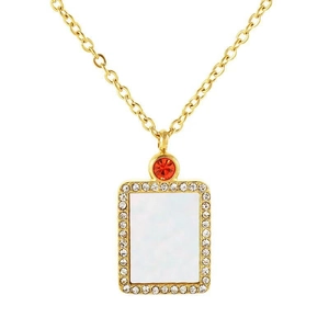 Gold shell pendant necklace with red zircon and sparkling rhinestones on white background
