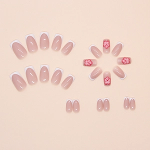Detailed view of French blush press-on nails with 3D red flower designs.