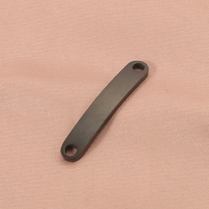 Close-up of a black stainless steel curved bar connector with dual holes on pink fabric