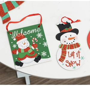 Detail of glittery Christmas wall hanging featuring Welcome and Let it snow signs