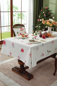 Festive Christmas polyester tablecloth with holly and snowflake patterns on wood table
