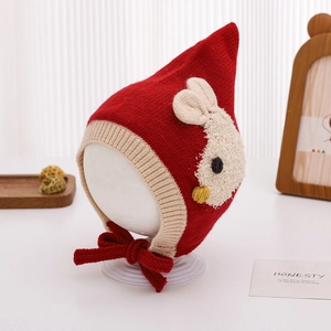 Detailed view of red knitted baby earflap hat featuring cute rabbit jacquard design