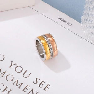 Detailed view of triple-tone metal ring band with sparkling central zircon inlay
