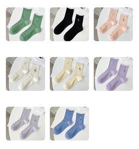 Detailed view of eight macaron colors cotton socks with delicate tulip embroidery details