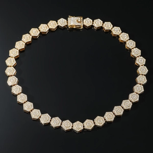 Golden hip hop necklace with hexagon links and pave diamonds on black background