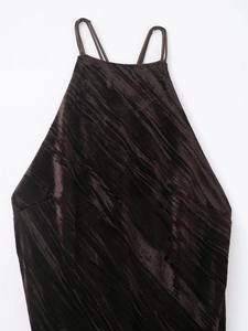 Detailed macro view of the dark brown velvet texture and thin spaghetti strap finish
