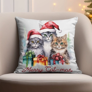 Close-up of a Christmas cat pillow case on a sofa with warm festive lighting