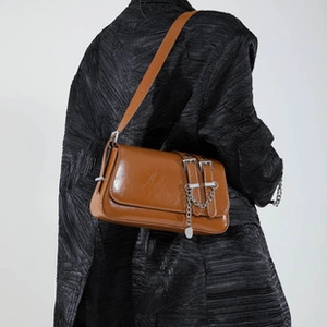Brown vintage glossy shoulder bag featuring silver metal chain and dual buckle straps