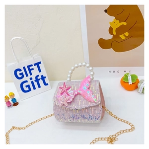 Detail of pink sequin mermaid bag with pearl handle and golden chain for little girls