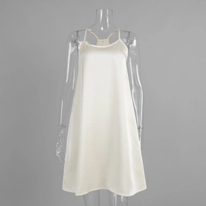 Detail view of cream satin mini dress featuring thin straps and back cross design