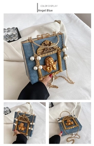 Detail of baroque angel relief and velvet texture on light blue crossbody bag with pearls