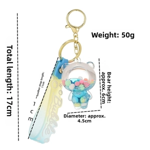 Macro detail of bear keychain with blue liquid glitter and Bubble silicone strap