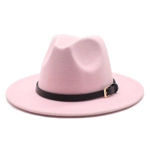 Detailed close-up of pink wool fedora hat with a black leather band and gold buckle