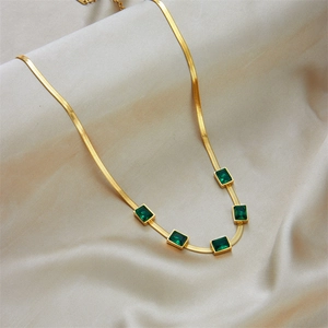 Elegant gold snake chain necklace with five emerald green rectangular gemstones