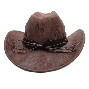 Detailed close-up of vintage brown cowboy hat with leather band and metal rivets