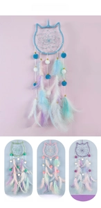 Detail view of owl-shaped dreamcatcher with feathers and beads in four pastel colors