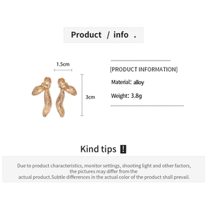 Detailed view of golden leaf earrings showing size 3cm by 1.5cm and product dimensions