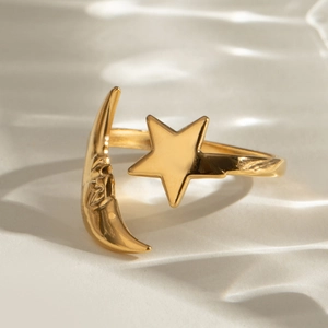 Macro detail of gold-plated open ring featuring a crescent moon face and star design